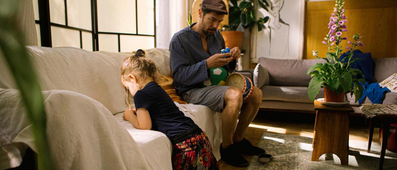 Man met dochter in de huiskamer